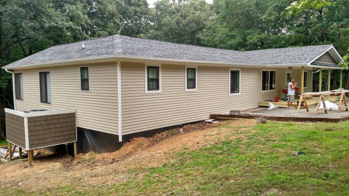 Boyd Roofing and Construction built the new porch and addition to the house with new vinyl, windows and roof!